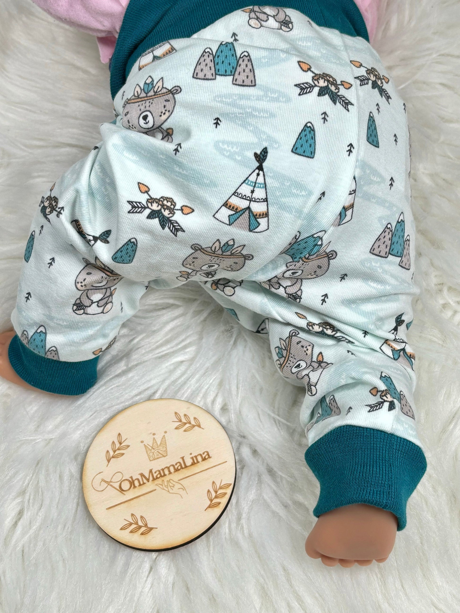 Handgemachte Baby Leggings mit Indianer-Bär-Motiv – an Baby-Puppe, Rückenansicht mit Windelschnitt